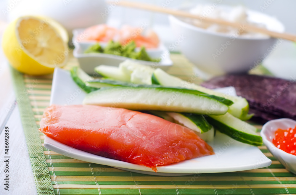 ingredients for sushi, sakmon and cucumber ingredients for sushi, sakmon and cucumber