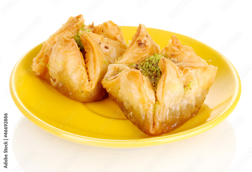 Sweet baklava on plate isolated on white Sweet baklava on plate isolated on white