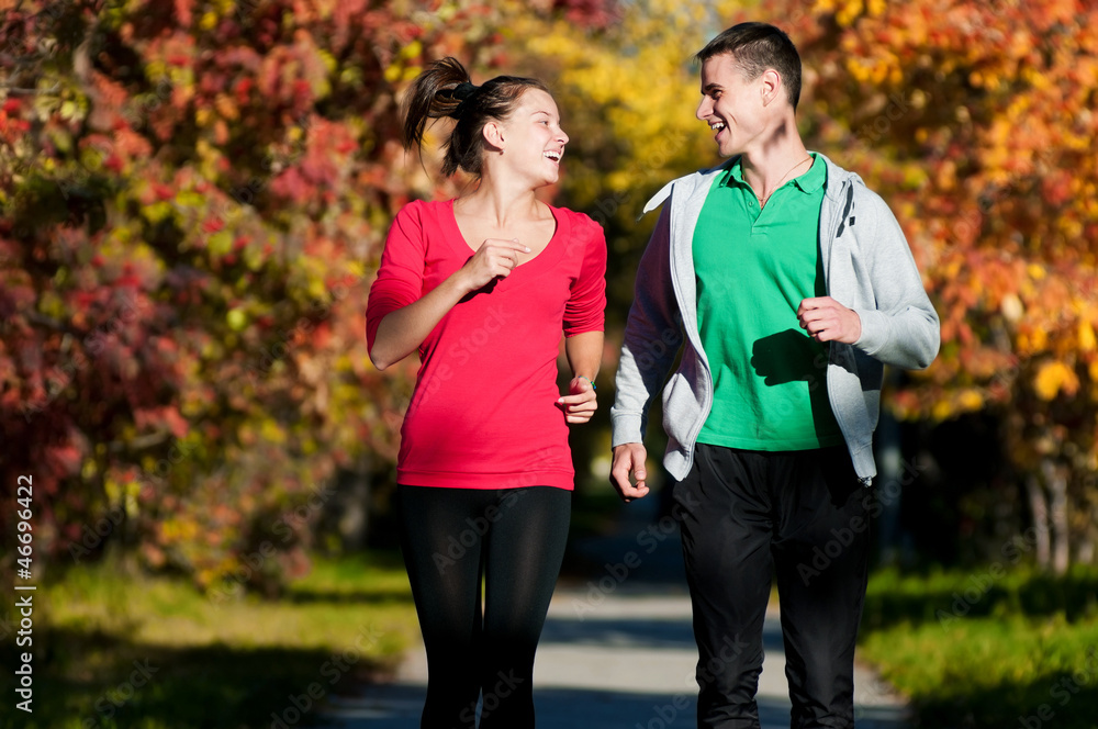Fototapeta premium Young man and woman running