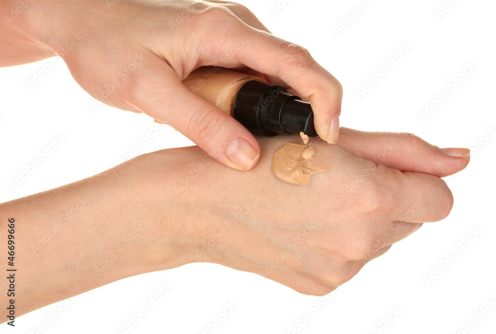 Woman applying concealer on hand on white background close-up