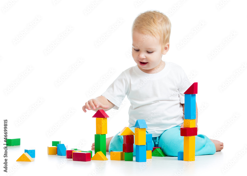 Happy kid playing toy blocks isolated on white background Happy kid playing toy blocks isolated on white background