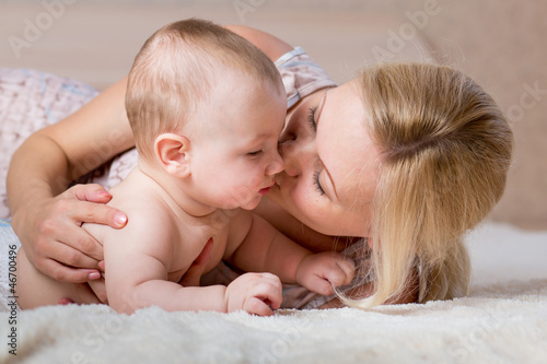 loving mother kissing her baby