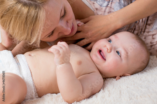 loving mother playing her baby