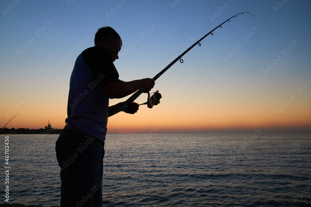 Fisherman fishes at the