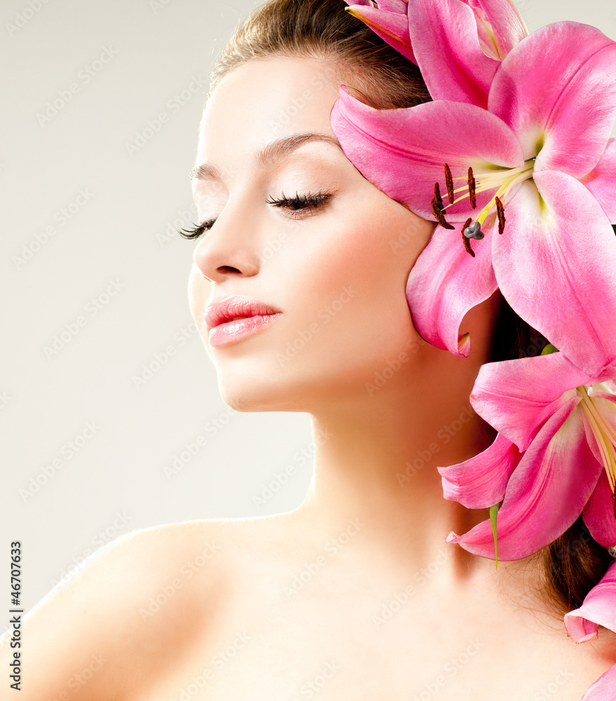 beautiful girl with pink lilies in her hair beautiful girl with pink lilies in her hair
