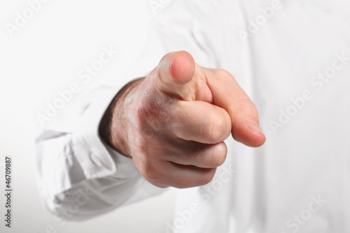 Photography index finger into lens on white background
