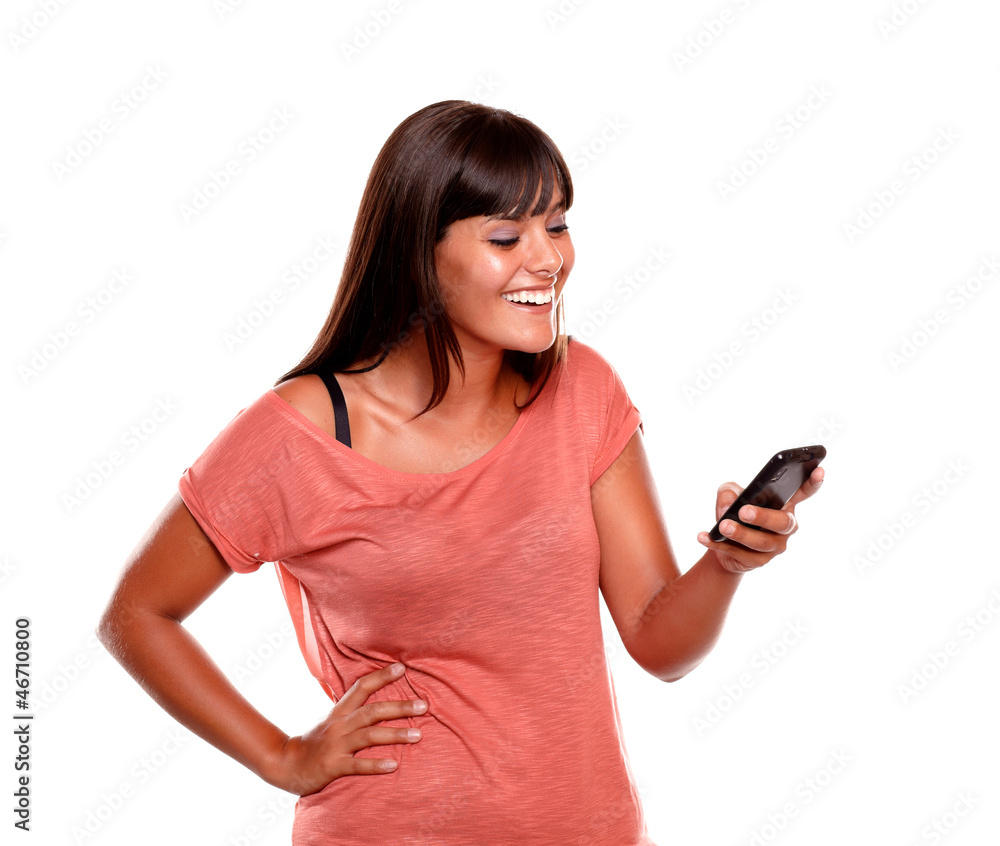 Young woman laughing while reading a message Young woman laughing while reading a message