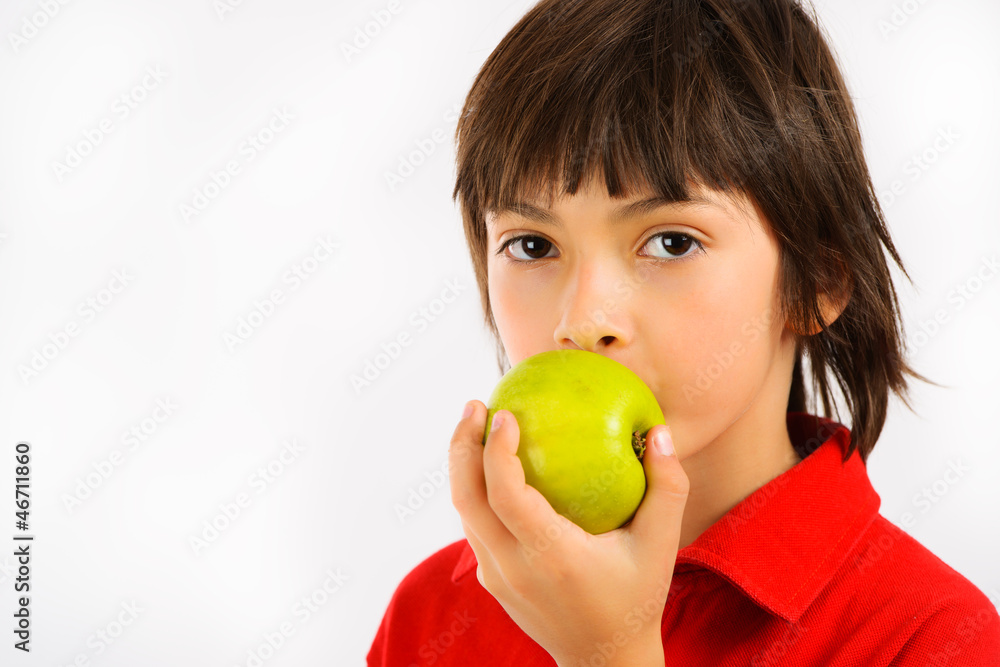 boy eating a green apple isolated on white background boy eating a green apple isolated on white background