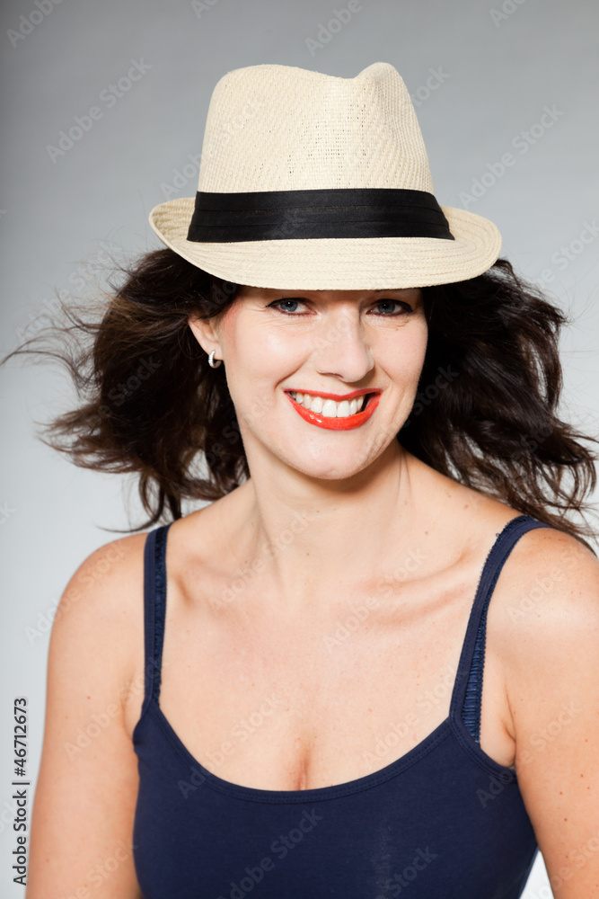 Pretty brunette woman with hat studio shot. Pretty brunette woman with hat studio shot.