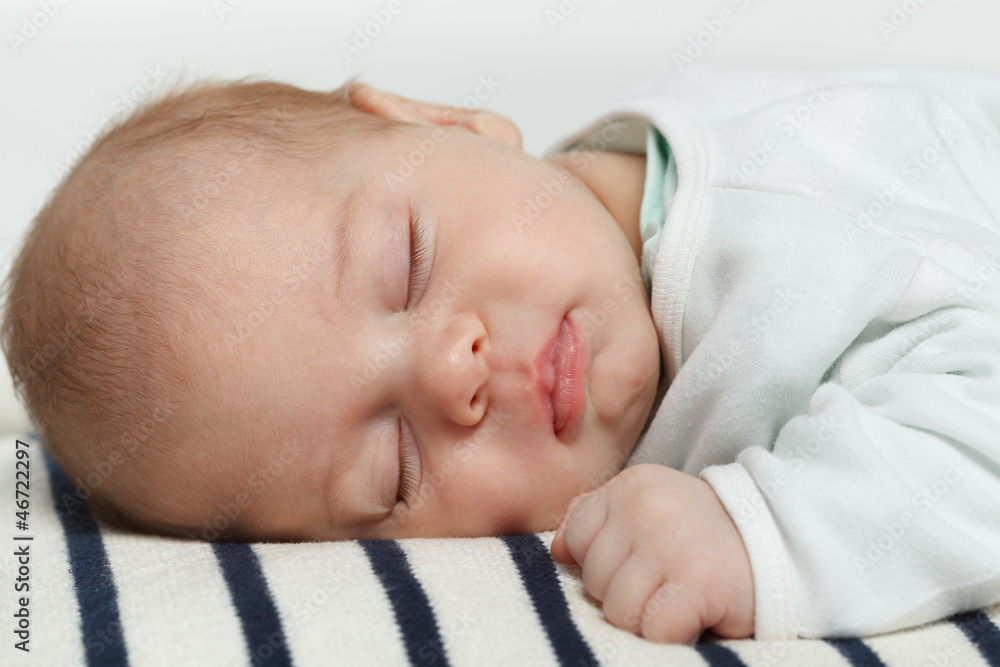 Closeup of newborn baby sleeping lying on his stomach