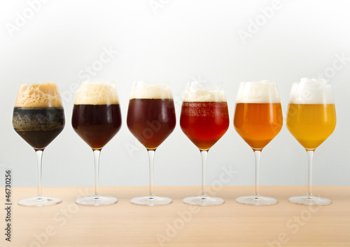 six glasses with different beers