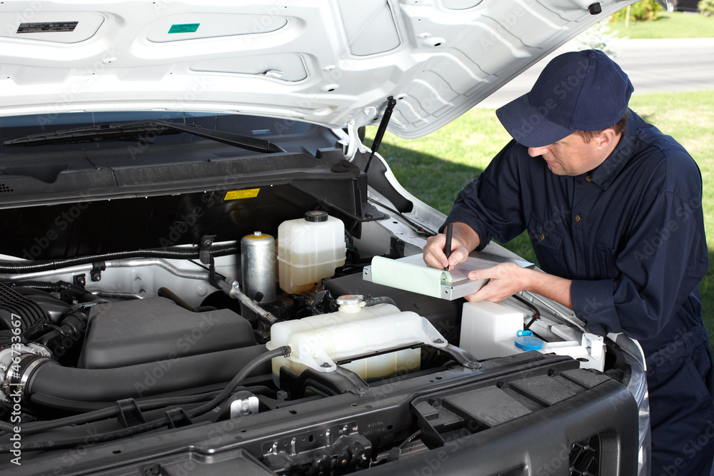Car mechanic working in auto repair service. Car mechanic working in auto repair service.