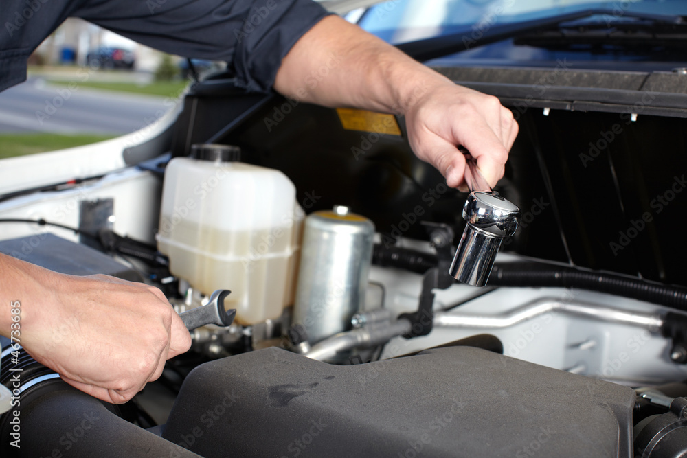 Car mechanic working in auto repair service. Car mechanic working in auto repair service.