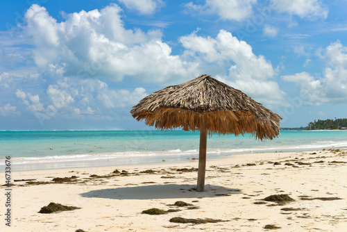 A straw umbrella on a beautiful tropical beach