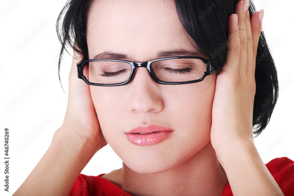 Frustrated young woman holding her ears Frustrated young woman holding her ears