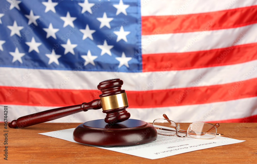 Divorce decree and wooden gavel on american flag background