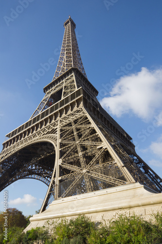 sunlit Eiffel Tower, Paris, against blue sky