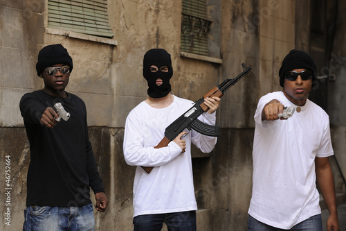 Gang members with guns and rifle on the street photo