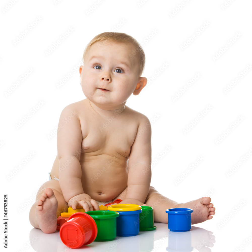 Baby playing with cup toys. Isolated on white background Baby playing with cup toys. Isolated on white background