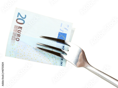 Banknotes on a fork on white background close-up