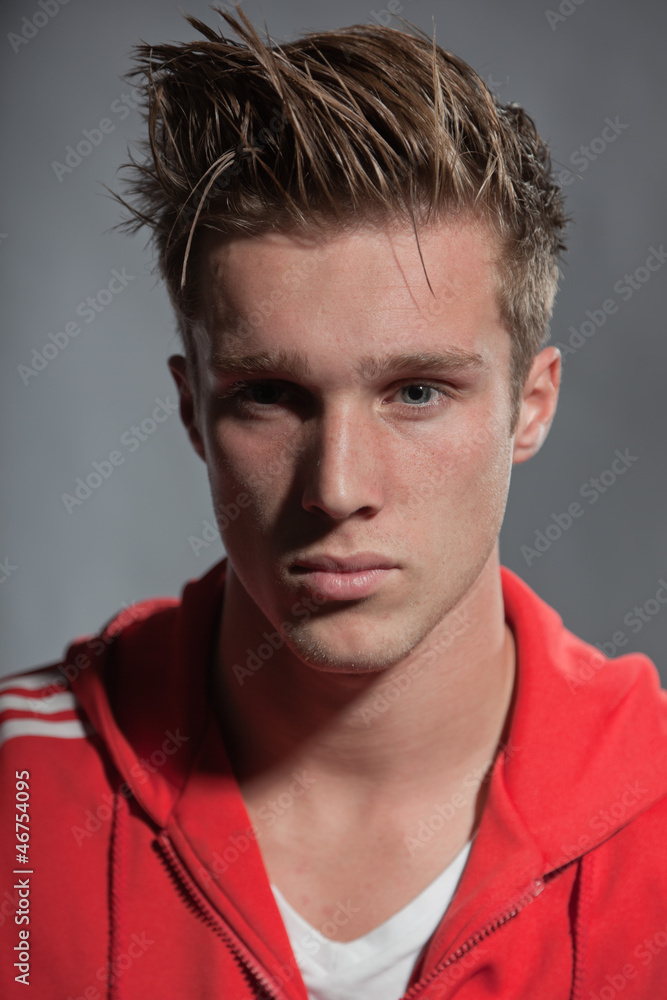 Obraz premium Fashion portrait of sportive young man wearing red jacket.