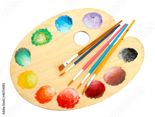 wooden art palette with paint and brushes isolated on white