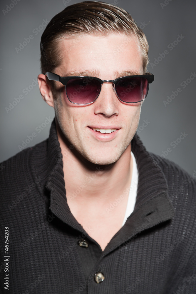 Fashion beauty portrait of young man with retro sunglasses.