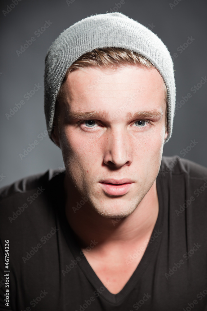 Winter fashion portrait of urban young man wearing woolen hat. Winter fashion portrait of urban young man wearing woolen hat.