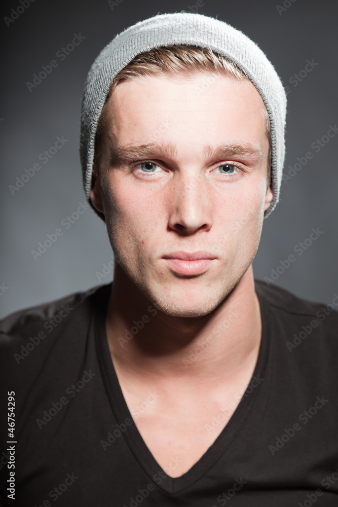 Winter fashion portrait of urban young man wearing woolen hat. Winter fashion portrait of urban young man wearing woolen hat.