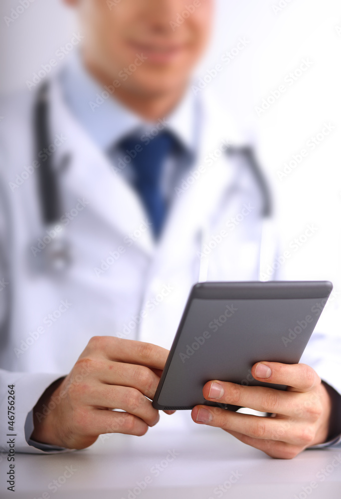 Handsome doctor using computer plane-table Handsome doctor using computer plane-table