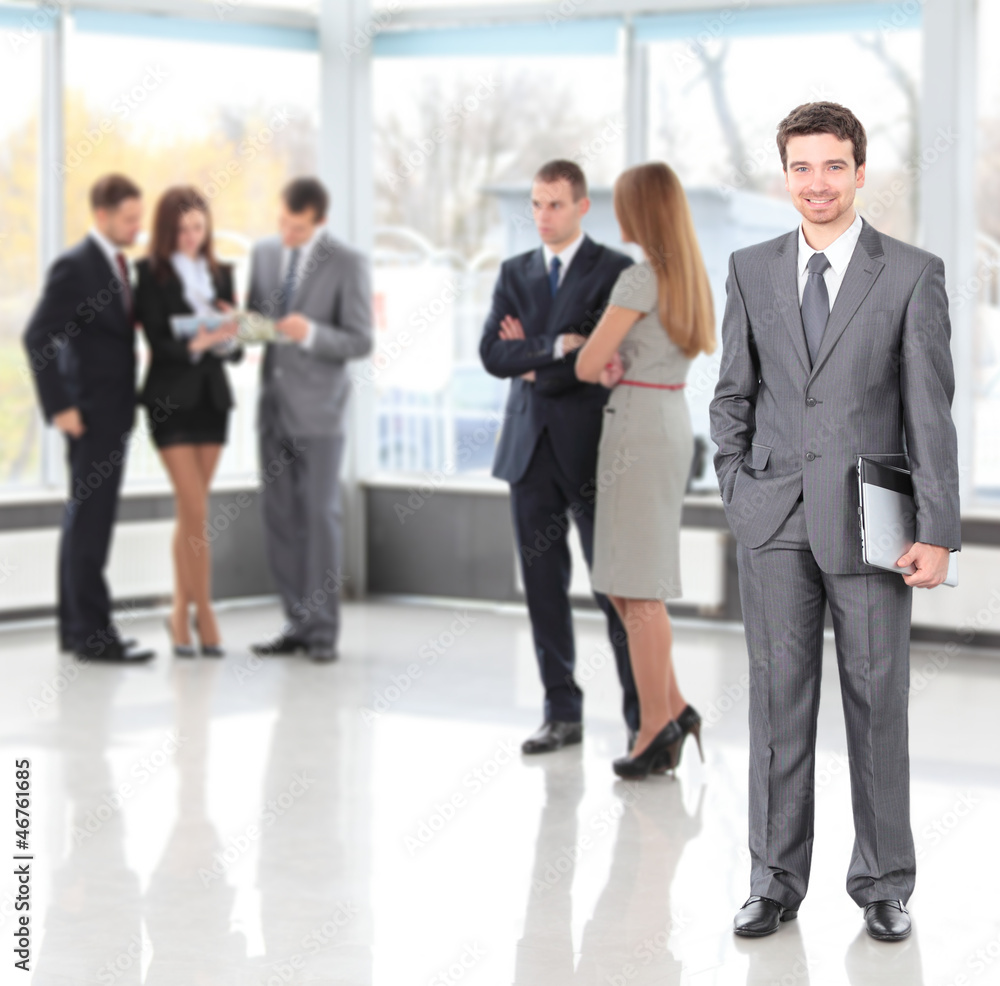 Happy smart business man with team mates discussing Happy smart business man with team mates discussing