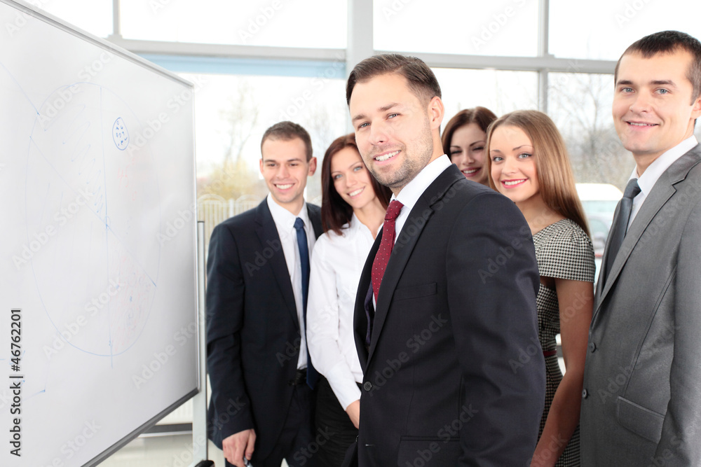 Business people looking at their leader while he explaining Business people looking at their leader while he explaining