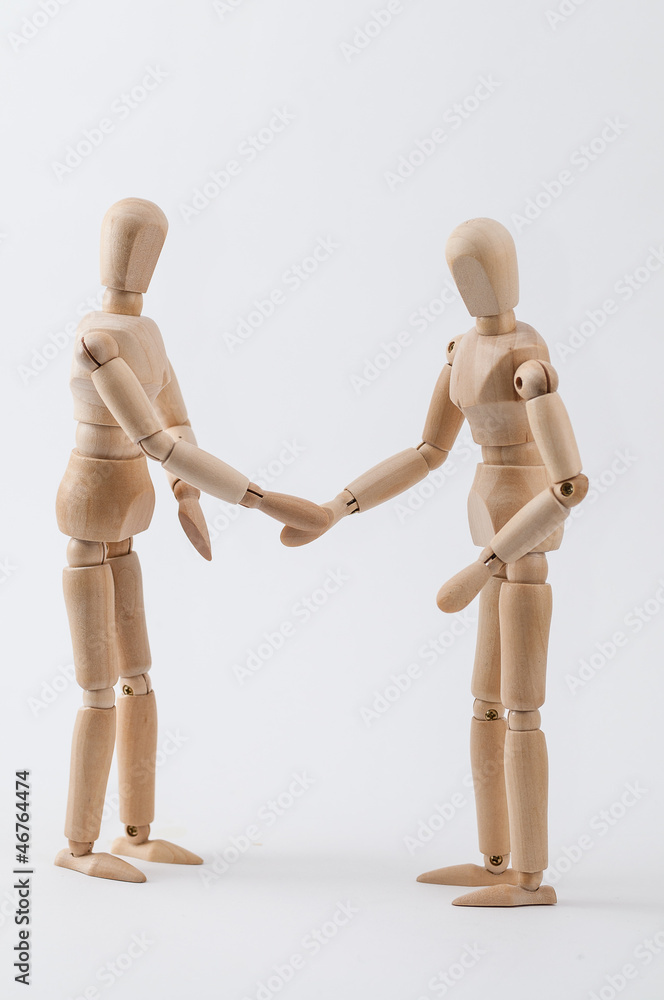 Zwei Zeichenpuppen geben sich die Hand Zwei Zeichenpuppen geben sich die Hand