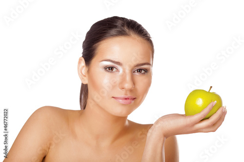 A portrait of beautiful young woman with a green apple
