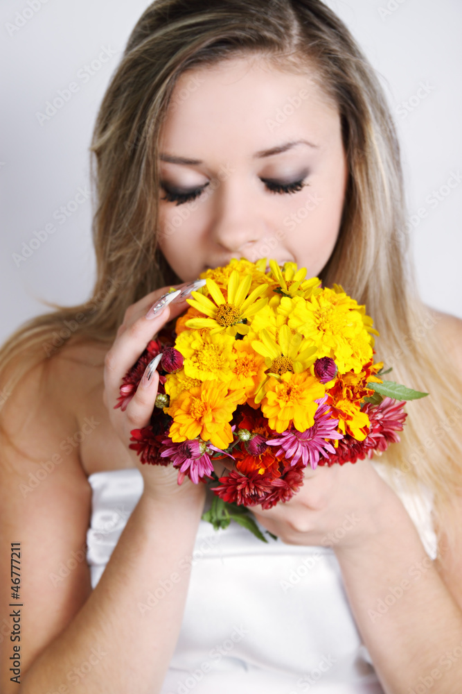 woman smelling a bouquet woman smelling a bouquet