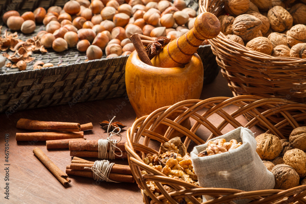 Walnuts, hazelnuts and cinnamon in wicker baskets Walnuts, hazelnuts and cinnamon in wicker baskets