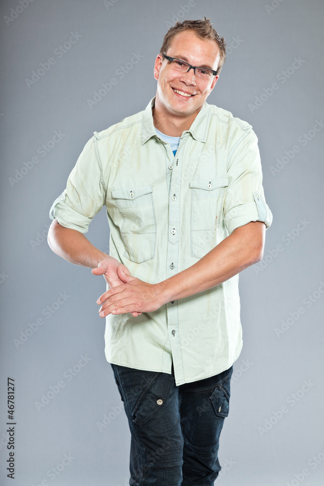 Casual fashion man with short hair against grey wall in studio. Casual fashion man with short hair against grey wall in studio.