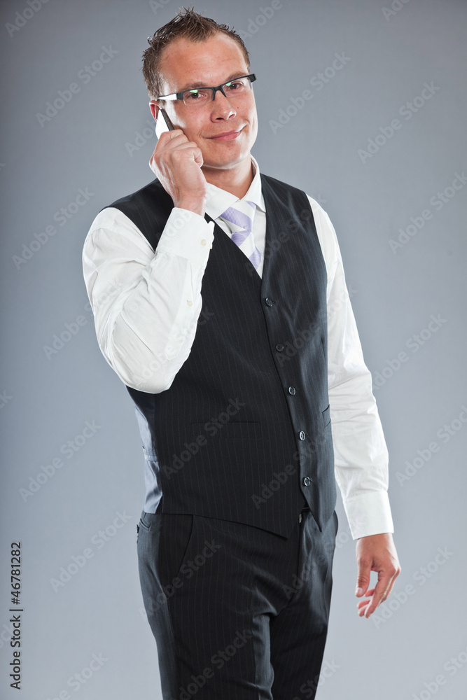 Young business man calling with mobile phone. Studio shot. Young business man calling with mobile phone. Studio shot.