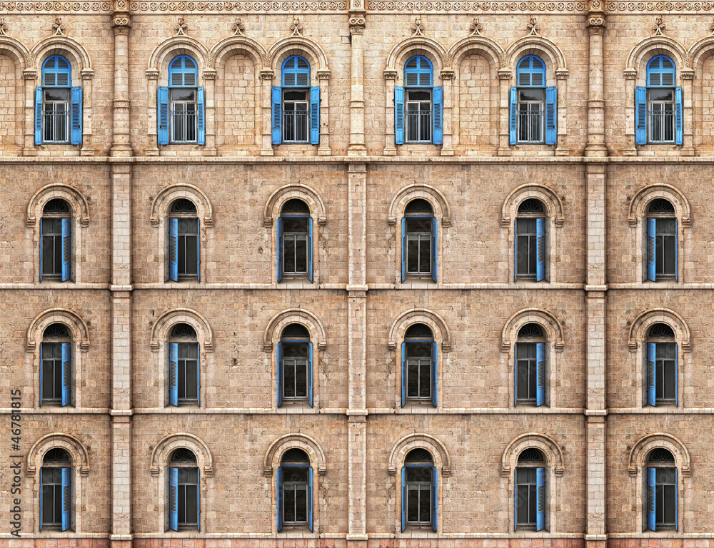 Wall with blue shuttered windows