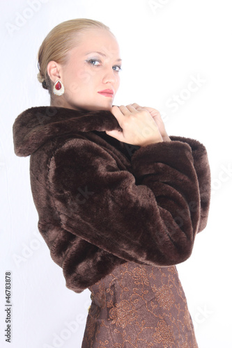 Elegant woman with brown coat, posing at the studio