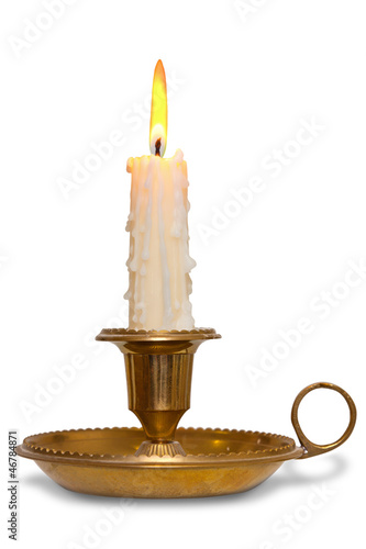 Candle in brass chamberstick holder isolated