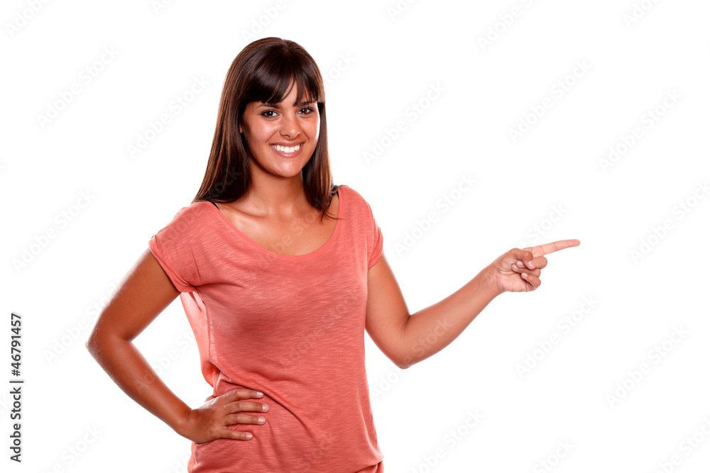 Stylish young woman looking at you pointing left Stylish young woman looking at you pointing left