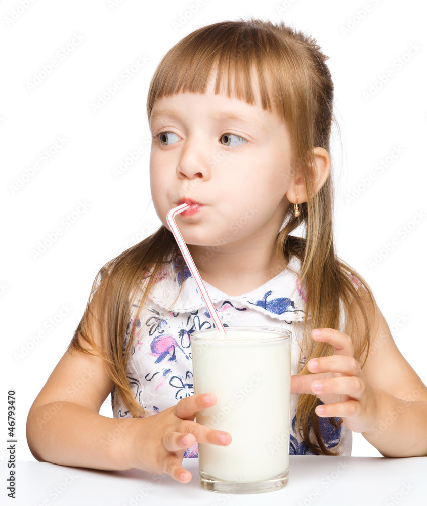 Cute little girl drinks milk using drinking straw Cute little girl drinks milk using drinking straw