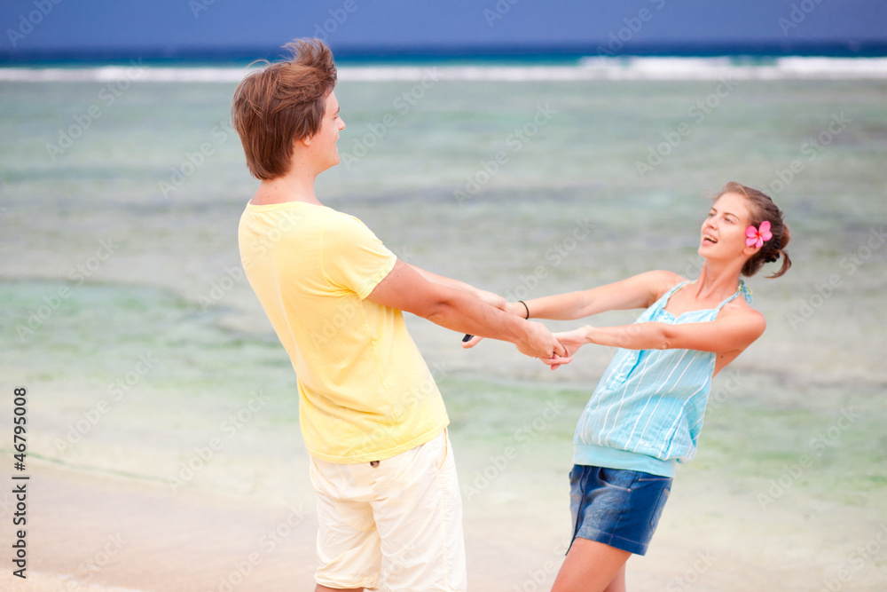 young happy couple having fun on tropical beach. honeymoon young happy couple having fun on tropical beach. honeymoon