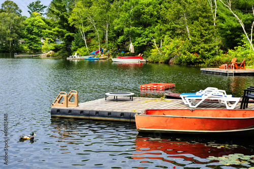 Fotografering Cottage lake with diving platform and docks