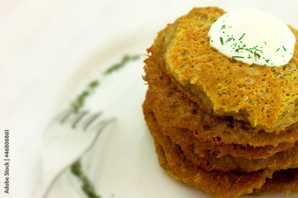 Homemade potato pancakes isolated on white plate Homemade potato pancakes isolated on white plate