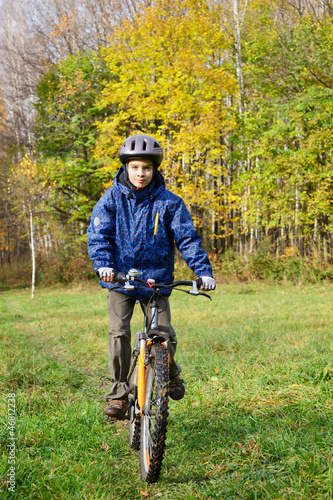 Boy riding bicycle in a park