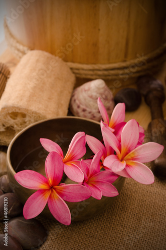 tropical spa setup with frangipani flower