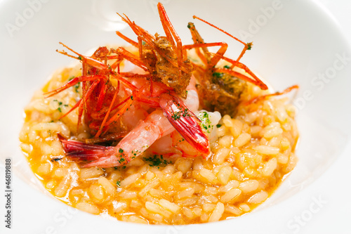 Creamy risotto rice dish with red prawns.