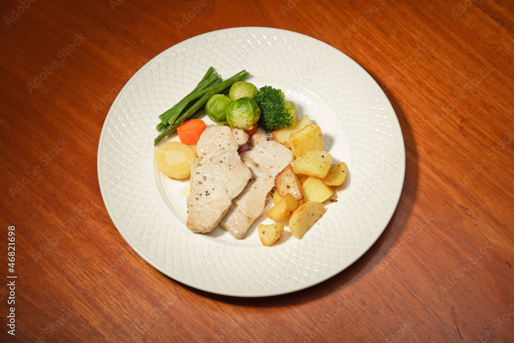 Dinner of vegetables potatoes and meat on a white plate. Dinner of vegetables potatoes and meat on a white plate.